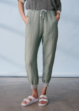 Sage green linen trousers with metallic trim