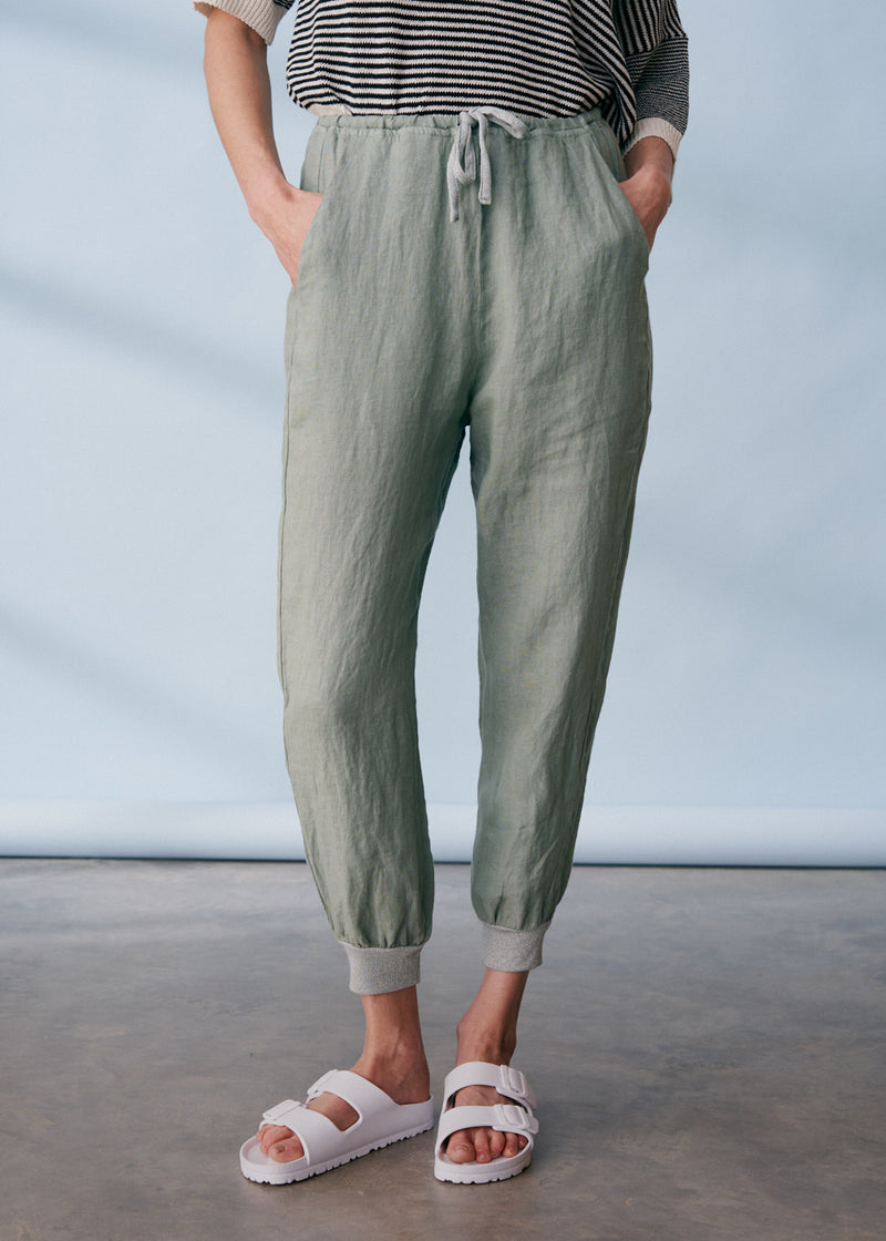 Sage green linen trousers with metallic trim