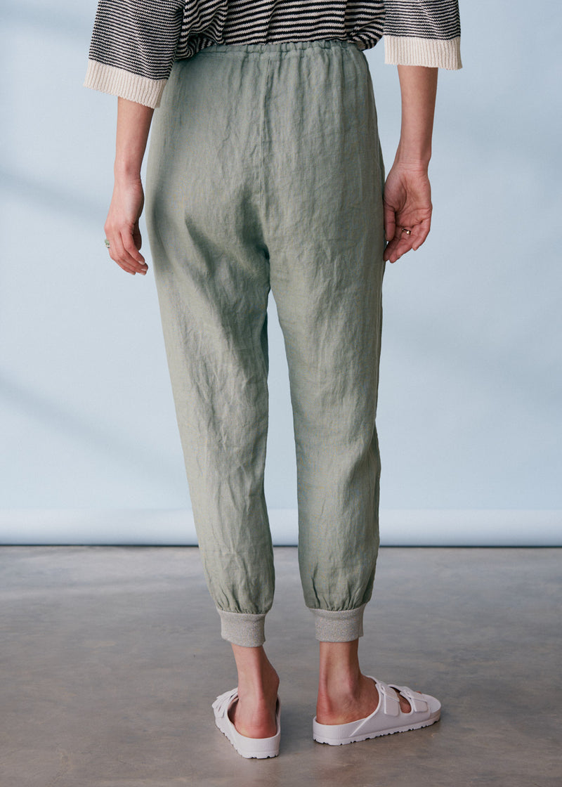 Sage green linen trousers with metallic trim