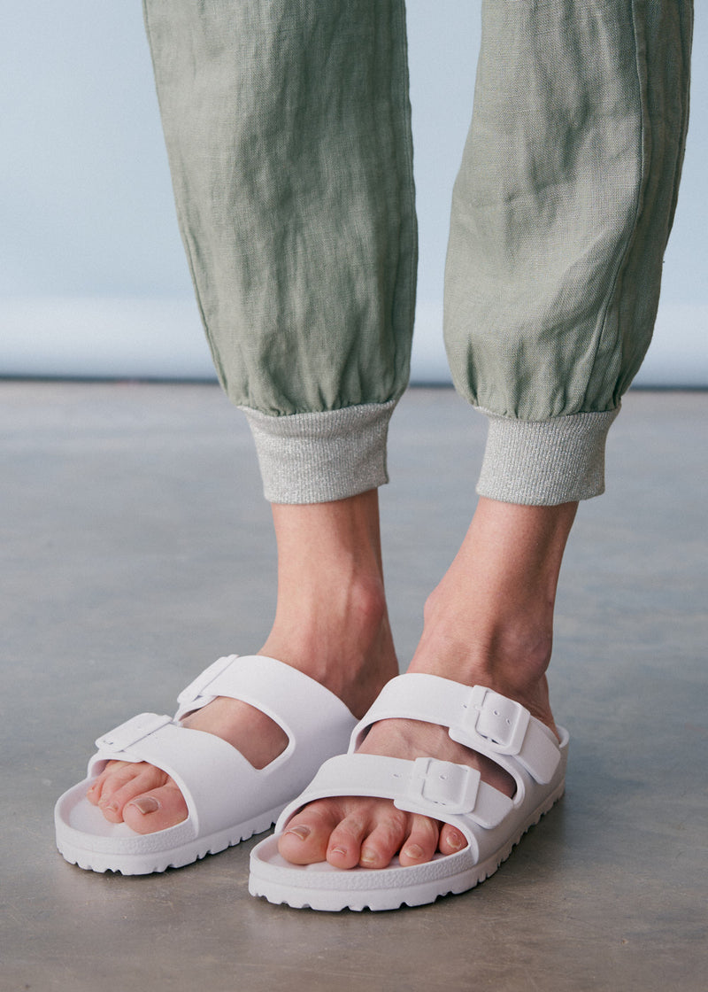 Sage green linen trousers with metallic trim