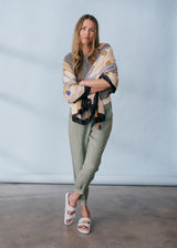 Sage green linen trousers with metallic trim