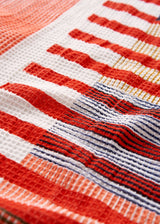 White waffle beach towel with red stripe pattern