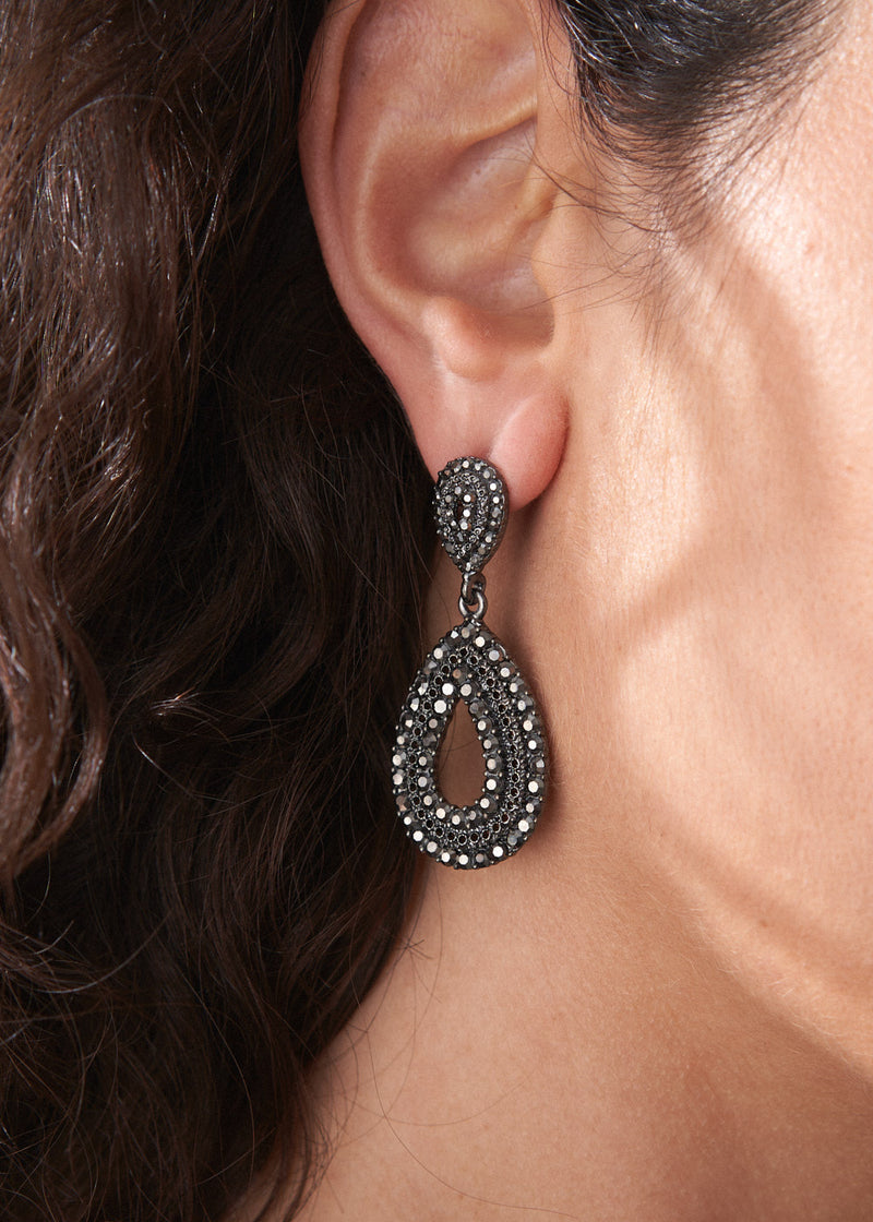 Women wearing Ainsley earrings featuring a striking teardrop silhouette embellished with jet-black crystals
