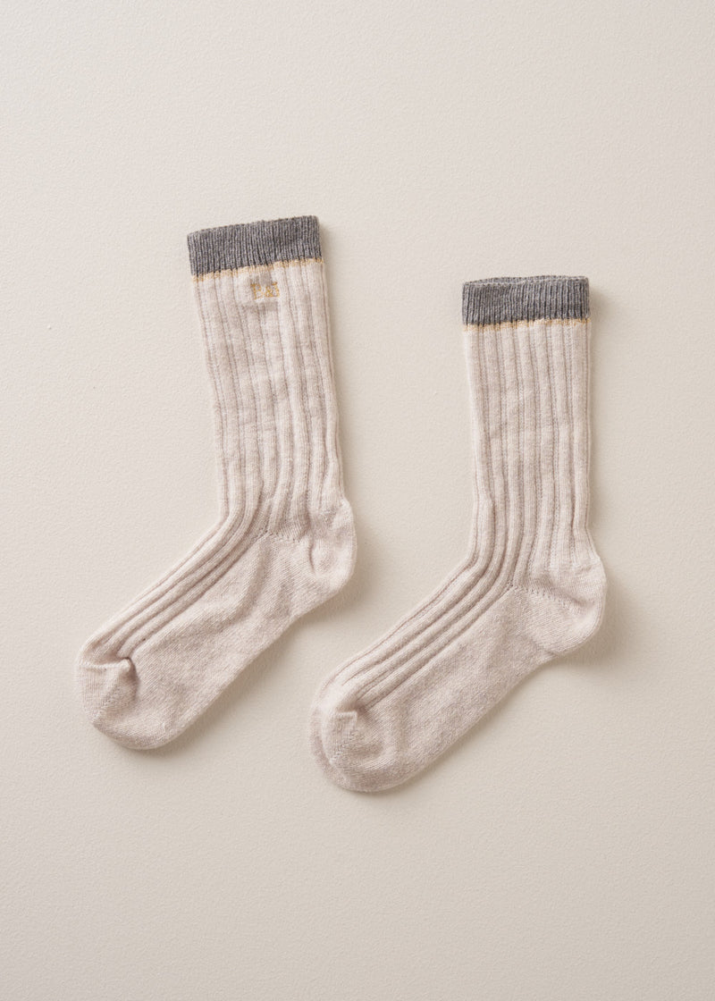 Heavy knit recycled wool blend socks in neutral and grey with metallic thread detailing and embroidered B&F monogram, on a beige background