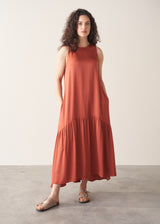 Woman wearing terracotta satin sleeveless midi dress
