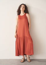 Woman wearing terracotta satin sleeveless midi dress