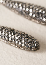 Close up of crystal detail on sparkly silver tear drop earrings.