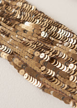 Close up of sequins on a gold sequin adorned scarf