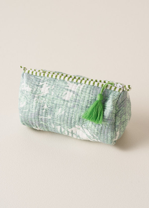 Quilted aqua palm zip wash bag on beige background