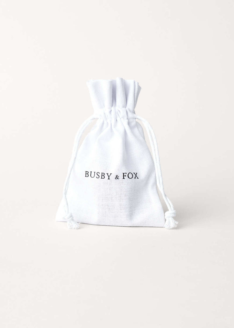 Large white drawstring jewellery bag with "Busby & Fox" branding