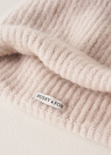 "Busby & Fox" branding on the inside of a cream, super soft, alpaca wool blend beanie hat