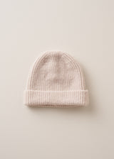 A cream, super soft, alpaca wool blend beanie hat on beige background