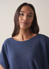 Woman wearing a navy blue sleeveless sweater