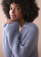 Close up of women wearing dusky lavender chunky oversized knit cardigan