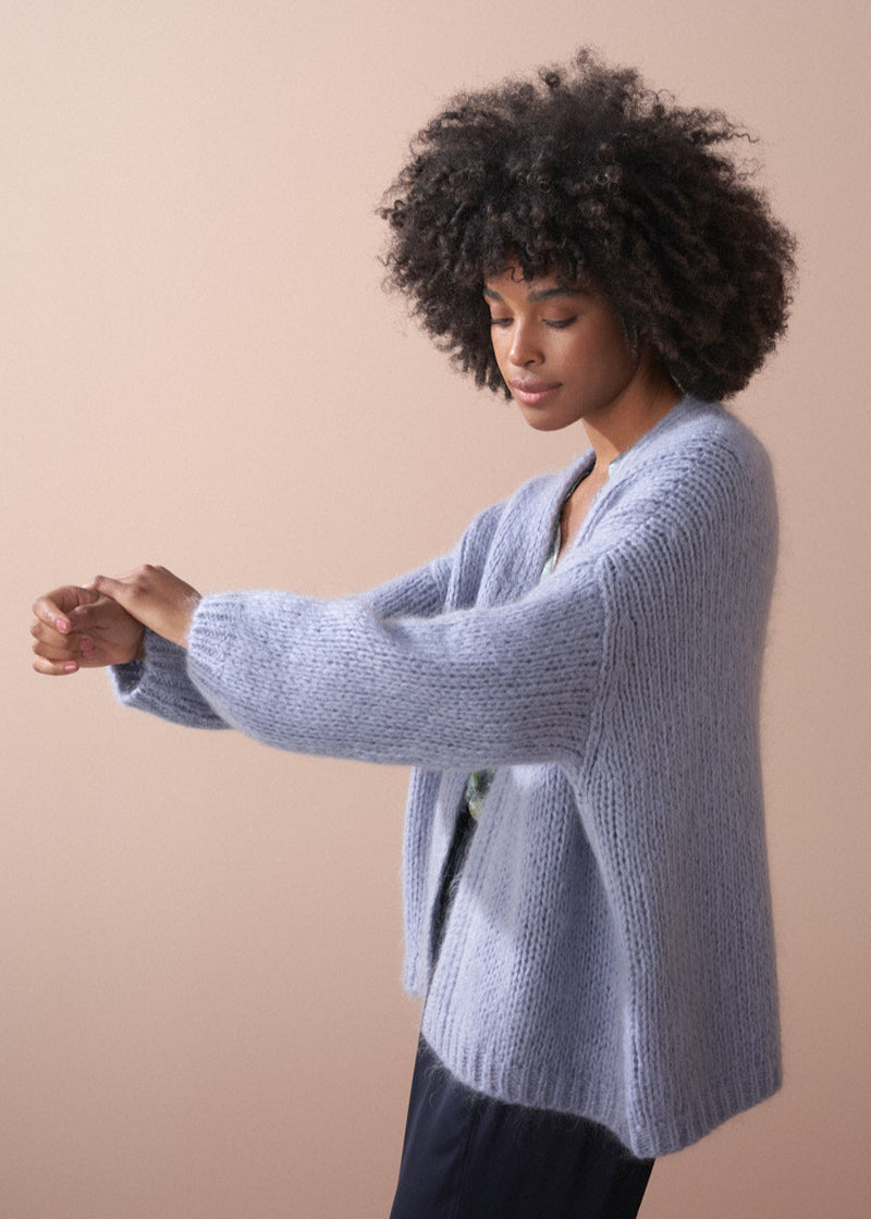 Woman wearing dusky lavender chunky oversized knit cardigan