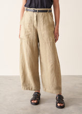A woman wearing like green linen wide leg cargo trousers and a black t-shirt