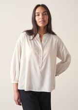 Woman wearing white cotton shirt with black trousers