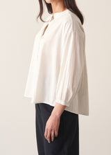 Woman wearing white cotton shirt with black trousers