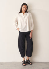 Woman wearing white cotton shirt with black trousers