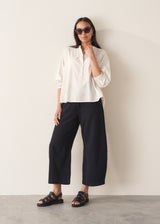 Woman wearing white cotton shirt with black trousers