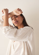 Woman wearing white cotton shirt with black trousers
