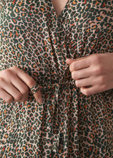 Woman wearing a leopard print wrap dress 