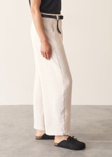 Woman wearing grey v-neck t-shirt and off white barrel leg trousers