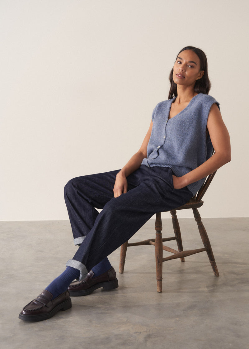 Woman wearing a blue sleeveless knitted waistcoat 