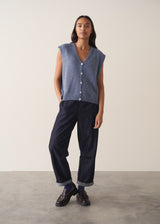 Woman wearing a blue sleeveless knitted waistcoat 