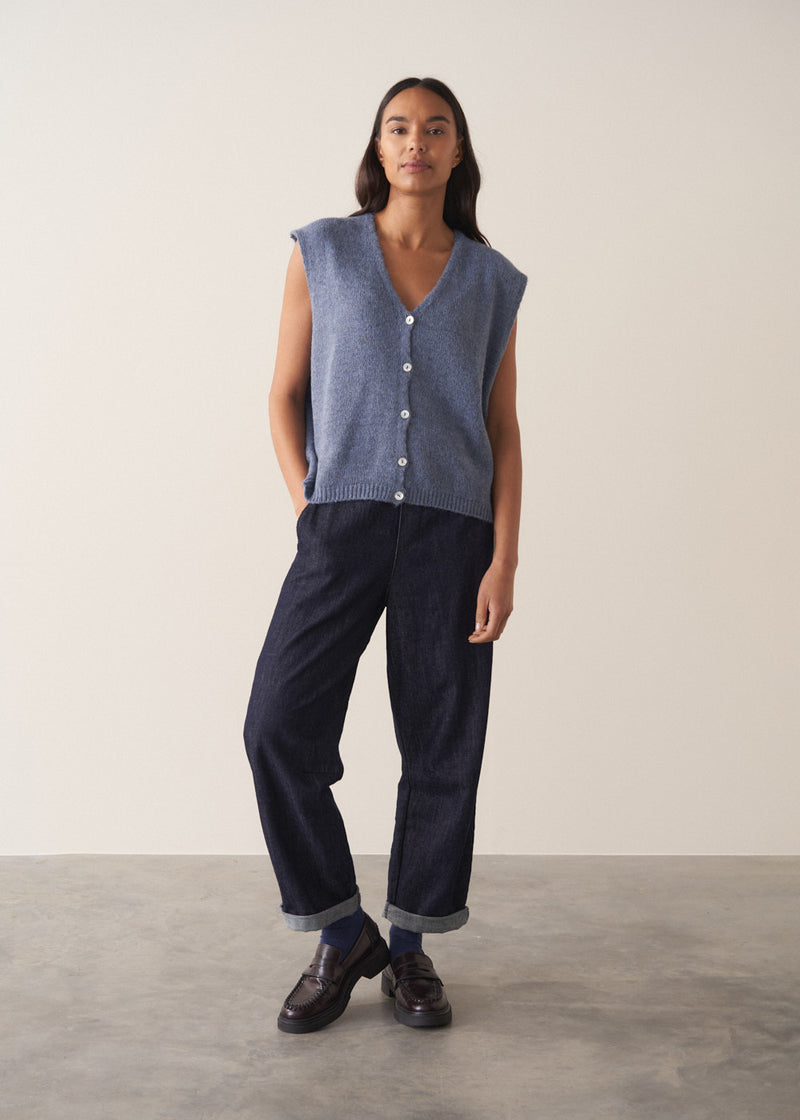 Woman wearing a blue sleeveless knitted waistcoat 