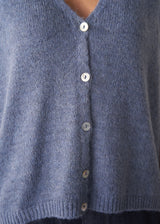 Woman wearing a blue sleeveless knitted waistcoat 