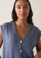 Woman wearing a blue sleeveless knitted waistcoat 