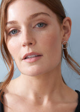 Model wearing silver double hoop drop earring