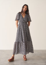 Woman wearing cotton block print dress with tiered skirt