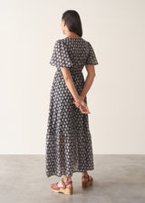Woman wearing cotton block print dress with tiered skirt