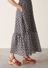 Woman wearing cotton block print dress with tiered skirt