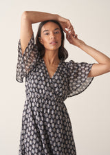 Woman wearing cotton block print dress with tiered skirt