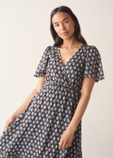 Woman wearing cotton block print dress with tiered skirt