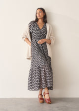 Woman wearing cotton block print dress with tiered skirt