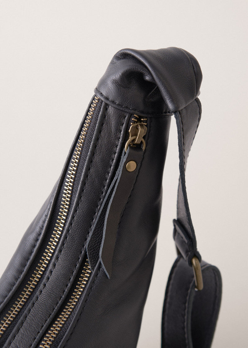 Black leather sling banana bag with zip fastening