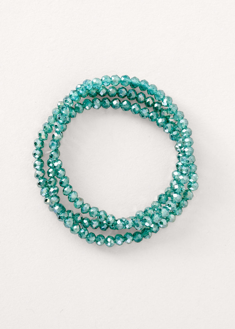 Teal blue crystal bracelet on neutral background