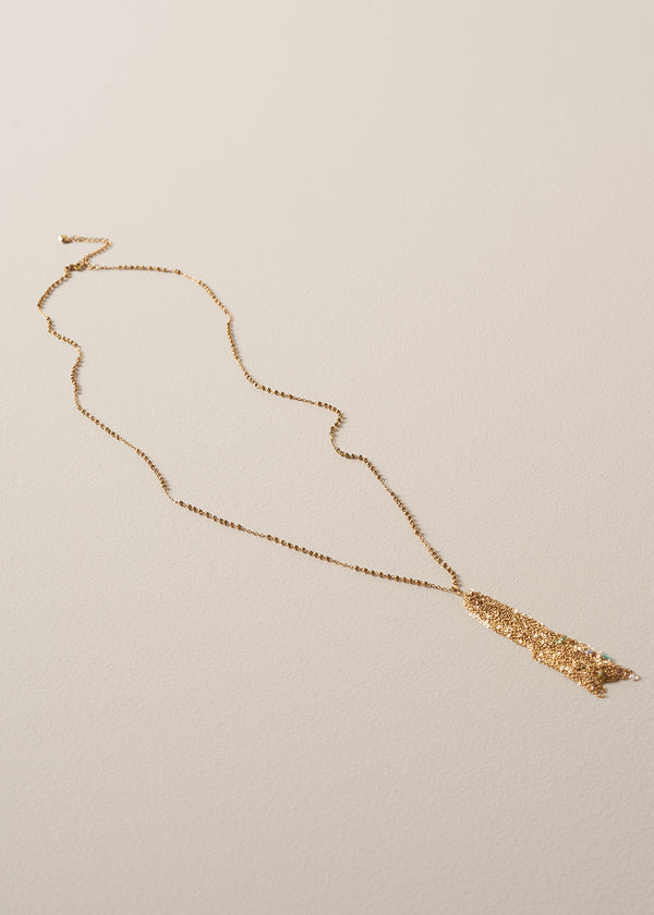 A long chain necklace with gold beads, finished with a multi-strand pendant, and colourful crystals