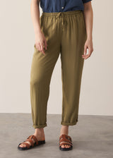 Woman wearing olive green trousers and blue linen shirt