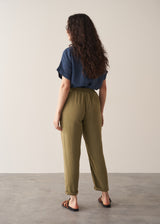 Woman wearing olive green trousers and blue linen shirt