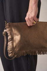 Bronze-coloured leather clutch bag with fringe details on a light gray background