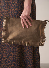 Bronze-coloured leather clutch bag with fringe details on a light gray background