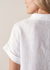 Woman wearing short sleeve white boxy linen shirt