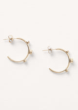 contemporary gold stud hoop earrings with crystal detail on white background