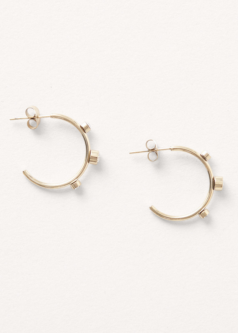 contemporary gold stud hoop earrings with crystal detail on white background