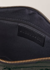 Black sequin clutch bag on a light beige background